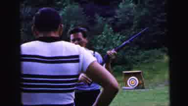 Camden New Jersey USA (1964): Man Giving Loaded Rifle To Shooting Partner To Shoot