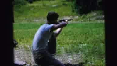 Camden New Jersey USA (1964): Man Lines Up A Shot Through A Gun Then With A Close