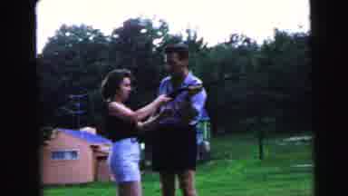 Camden New Jersey USA (1964): Man Teaching Woman To Shoot Gun