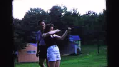 Camden New Jersey USA (1964): Woman Shooting With A Gun And A Man Looking In The