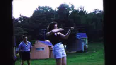 Camden New Jersey USA (1964): Gun Woman Mid-Age Hair Shorts Backyard Man Shoot Old