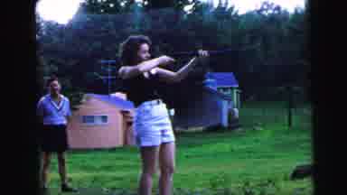 Camden New Jersey USA (1964): Woman Aims A Shotgun