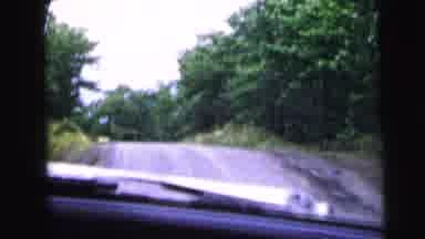 Camden New Jersey USA (1964): People Driving Down The Street Pass Lots Of Woods