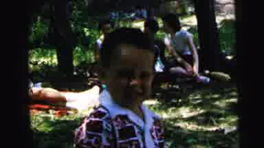Camden New Jersey USA (1964): Little Boy In Square Shirt Watches Man Pick Up