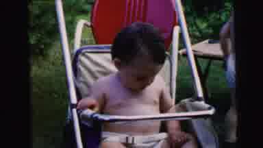Camden New Jersey USA (1964): Baby Swung In A Stroller Bites His Hand