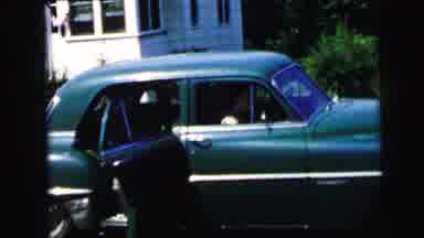 Camden New Jersey USA (1964): Person Gets Into The Back Of A Car In The Driveway