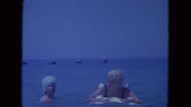Clearwater Florida (1964): Woman In Bathing Cap Tips Over Woman On Inflatable Pool