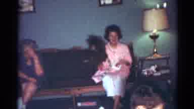 Cleveland Ohio (1964): People Sitting In A Room Talking And An Older Lady Trying
