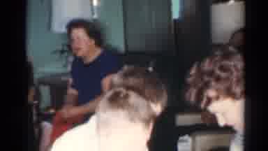 Cleveland Ohio (1964): Woman Wearing Black And White Checked Dress Hands Items To
