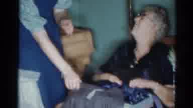 Cleveland Ohio (1964): Girl Wearing Blue Overalls Helps Elderly Woman Unwrap Gift