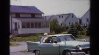 Elkhart Illinois USA (1964): Man And Lady Parking A Big Green Car In A Driveway