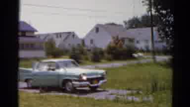 Elkhart Illinois USA (1964): Woman Wearing Pink Dress Carries Small Child Away