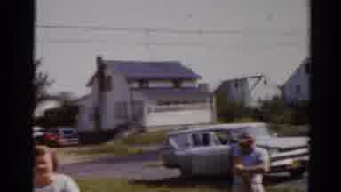 Elkhart Illinois USA (1964): A Man And Woman And Two Boys Exit A Station Wagon And