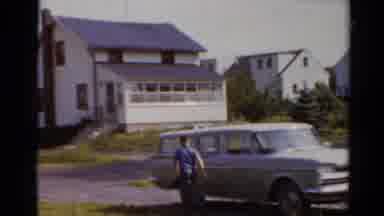 Elkhart Illinois USA (1964): Small Boy Runs Around The Side Of The Family Case To