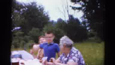 Elkhart Illinois USA (1964): Big Family Having A Meal Outside In A Sunny Day