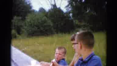 Elkhart Illinois USA (1964): Three Young Children Sitting Outside On A Picnic