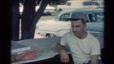 Elkhart Illinois USA (1964): Man Wearing White Shirt Talks To Person Wearing Blue