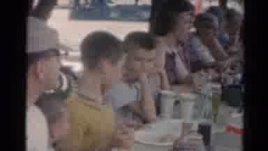 Elkhart Illinois USA (1964): Family Of Varying Ages Sit At Table Together To Share