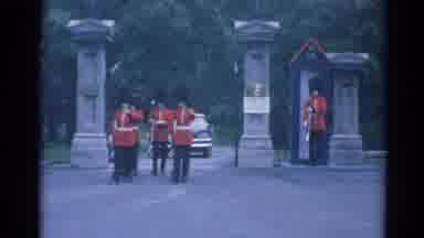 Elkhart Illinois USA (1964): British Troops In Dress Uniform March Through A Gate