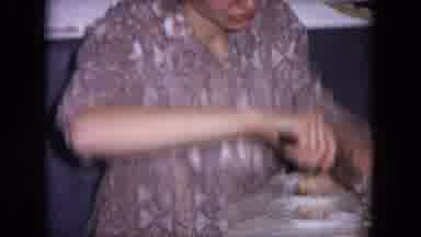 Evanston Illinois (1964): Woman Carefully Cutting A White Cake With Vanilla Icing