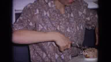 Evanston Illinois (1964): Young Woman In Patterned Shirt Carving And Plating Meat