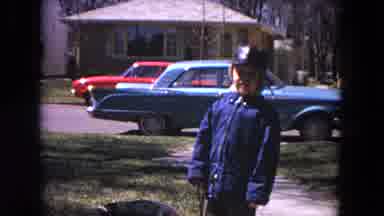 Evanston Illinois (1964): Boy Wearing Blue Coat Holds Black Dog On Leash While