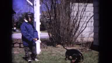Evanston Illinois (1964): Kid Dressed In Warm Clothes In His Front Yard Attempting