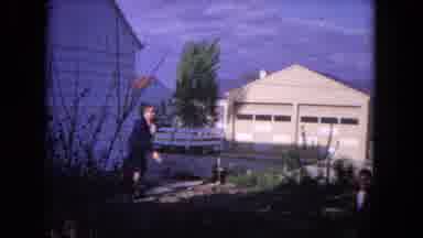 Evanston Illinois (1964): A Man Next To A Building Throwing A Parachute Toy Into
