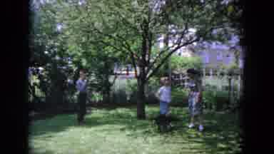 Evanston Illinois (1964): Woman Wearing Blue Dress Hugs Boy Holding Black Dog On