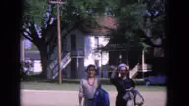 Evanston Illinois (1964): Two Well-Dressed Women Walk Across A Field In Front Of