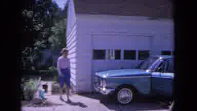 Evanston Illinois (1964): Woman Skips And Little Boy And Sausage Dog In Driveway