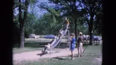 Evanston Illinois (1964): Children Pile Onto The Slide And All Go Down It Together