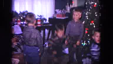 Evanston Illinois USA (1964): Very Excited Children Bounce Around The Christmas