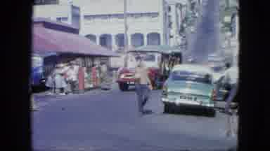 Grenada (1964): Congested Streets Crowded With People And Motor Vehicles In The