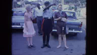 Grenada (1964): A Group Of People Walking Around On A Stage And A Policeman