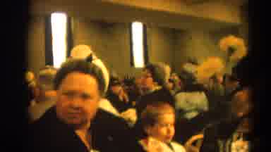 Harvard Illinois USA (1964): Older Lady In Formal Dress Chewing While Young Boy