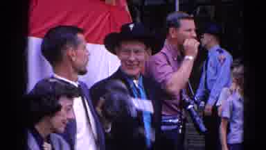 Harvard Illinois USA (1964): Man In Cowboy Hat Points Out Camera To Man In The