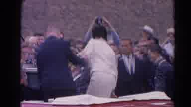 Harvard Illinois USA (1964): A Woman And Man Get Out Of A Car Into A Crowd Of