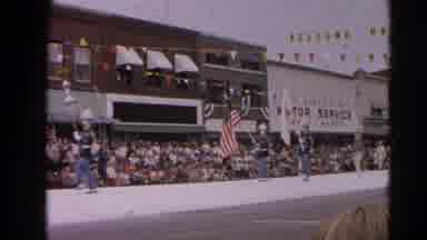 Harvard Illinois USA (1964): Flag Bearers And Band Marching In Parade On A Clear