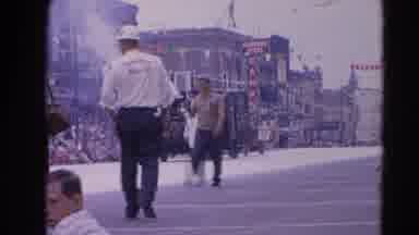 Harvard Illinois USA (1964): A Crowd Of People Watching A Car Passing In The