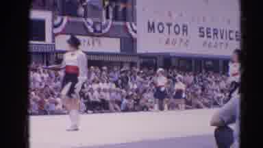 Harvard Illinois USA (1964): People Marching In Parade Outside Auto Parts Store