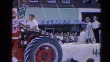 Harvard Illinois USA (1964): Red Tractor Pulling A Trailer With Bales Of Hay At A