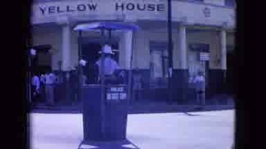 Kingston Jamaica (1964): Police Officer Waves Traffic By In Front Of A Yellow