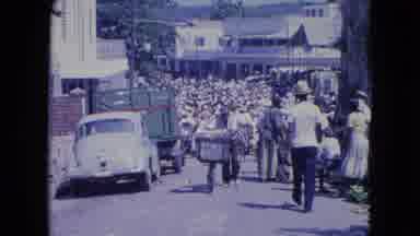 KINGSTON JAMAICA-1964: Bustling Street Market With Classic Car And Crowded Pedestrians