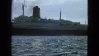 Martenique (1964): A Very Large Cruise Ship Is Seen Pulling Away From Shore On A