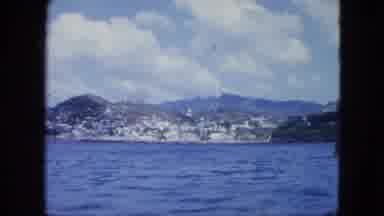Martenique-1964: A Ship Showing The Vast Mountain Region Alongside Deep Clear