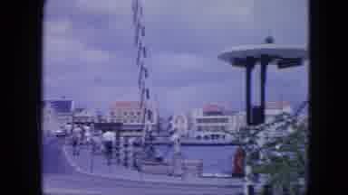 Nassau Bahamas-1964: People And Cars Traveling Along The Boardwalk