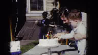 Niagra Falls New York (1964): Young Smiling Woman Helping A Little Boy Cut His