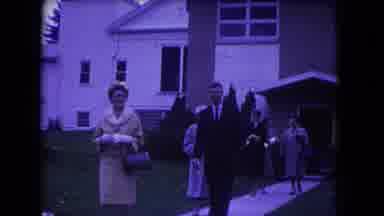 Niagra Falls USA (1964): A Few People Walk Slowly Out Of A Building In Formal