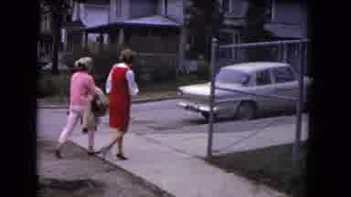 Niagra Falls USA (1964): Two Women Walk Down A Sidewalk And Another Woman Carries
